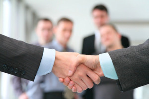 shaking hands with wrists and business team